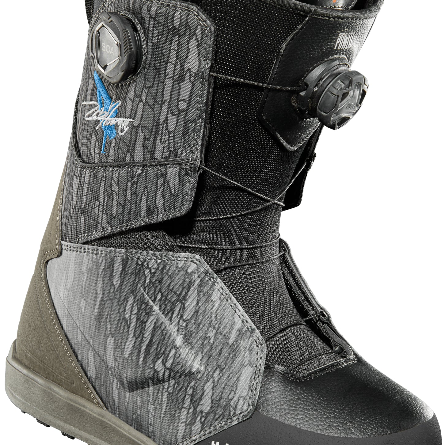 ThirtyTwo Lashed Double BOA x Powell Snowboard Boot 2025 - A black and grey snowboard boot with a blue logo on the side, featuring two BOA dials.