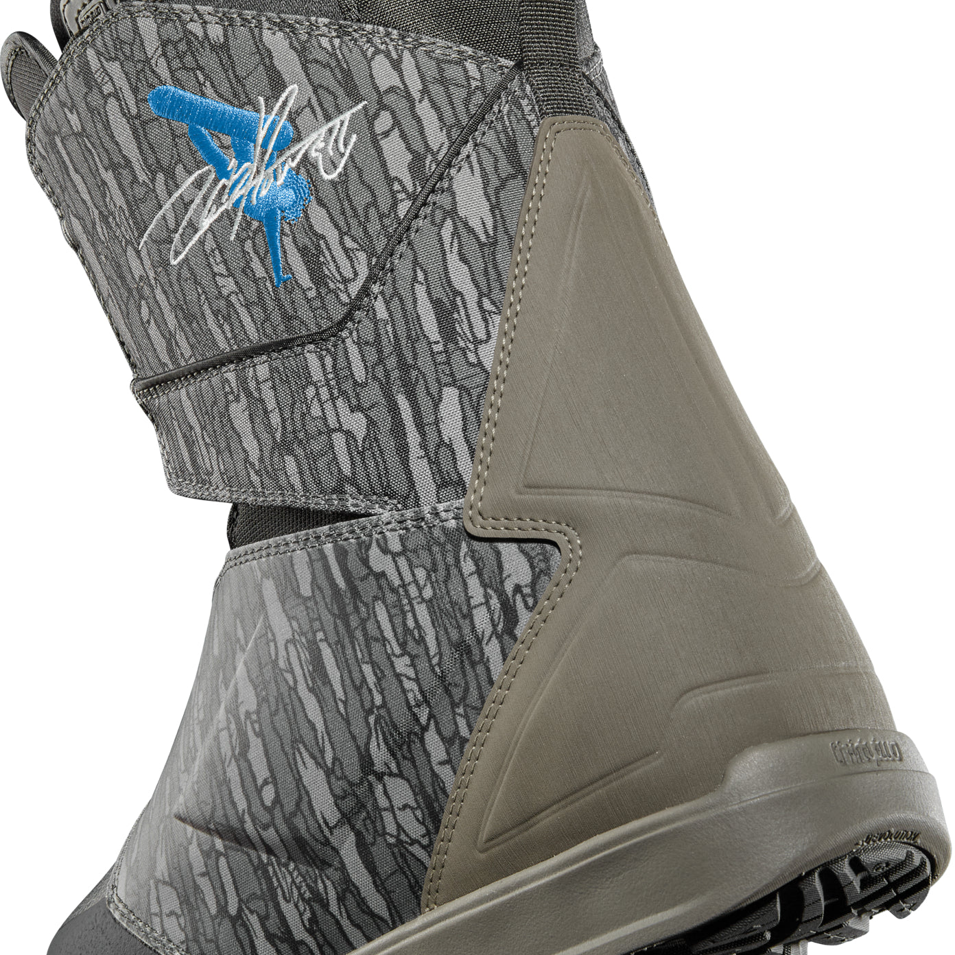 ThirtyTwo Lashed Double BOA x Powell Snowboard Boot 2025 - A gray snowboard boot with a blue logo featuring a stick figure in a backflip on the side.