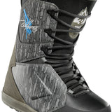 ThirtyTwo Lashed x Powell Snowboard Boot 2025 - A black and white snowboard boot with a blue logo on the side, featuring a textured pattern.