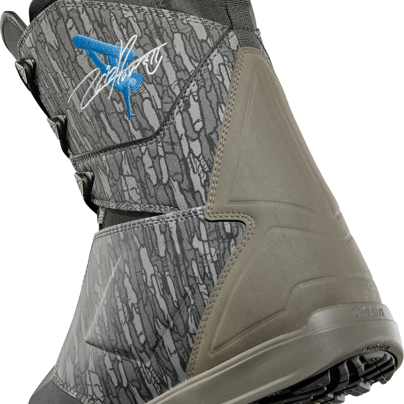 ThirtyTwo Lashed x Powell Snowboard Boot 2025 - A gray snowboard boot with a blue logo featuring a white outline of a lashed strap and the word "Lashed" in cursive script.
