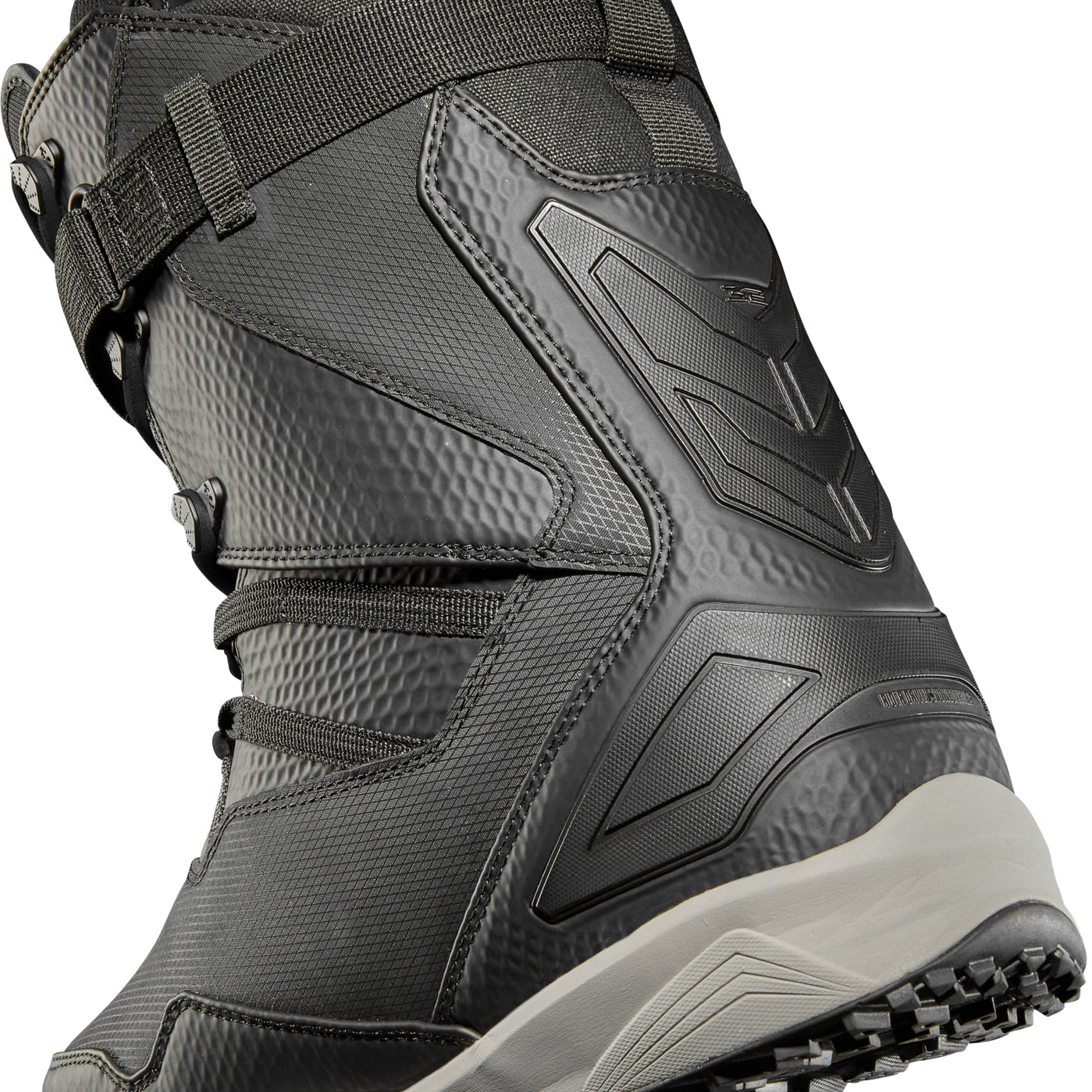 ThirtyTwo TM-2 XLT X Helgason Snowboard Boot 2025 - A black snowboard boot with a textured pattern on the side and a white logo on the tongue.