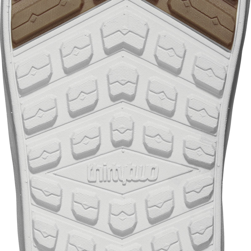 ThirtyTwo Lashed Double BOA Wide Snowboard Boot 2025 - A tan snowboard boot with a textured, rubber outsole and a white upper section featuring a diagonal pattern of darker brown lines.