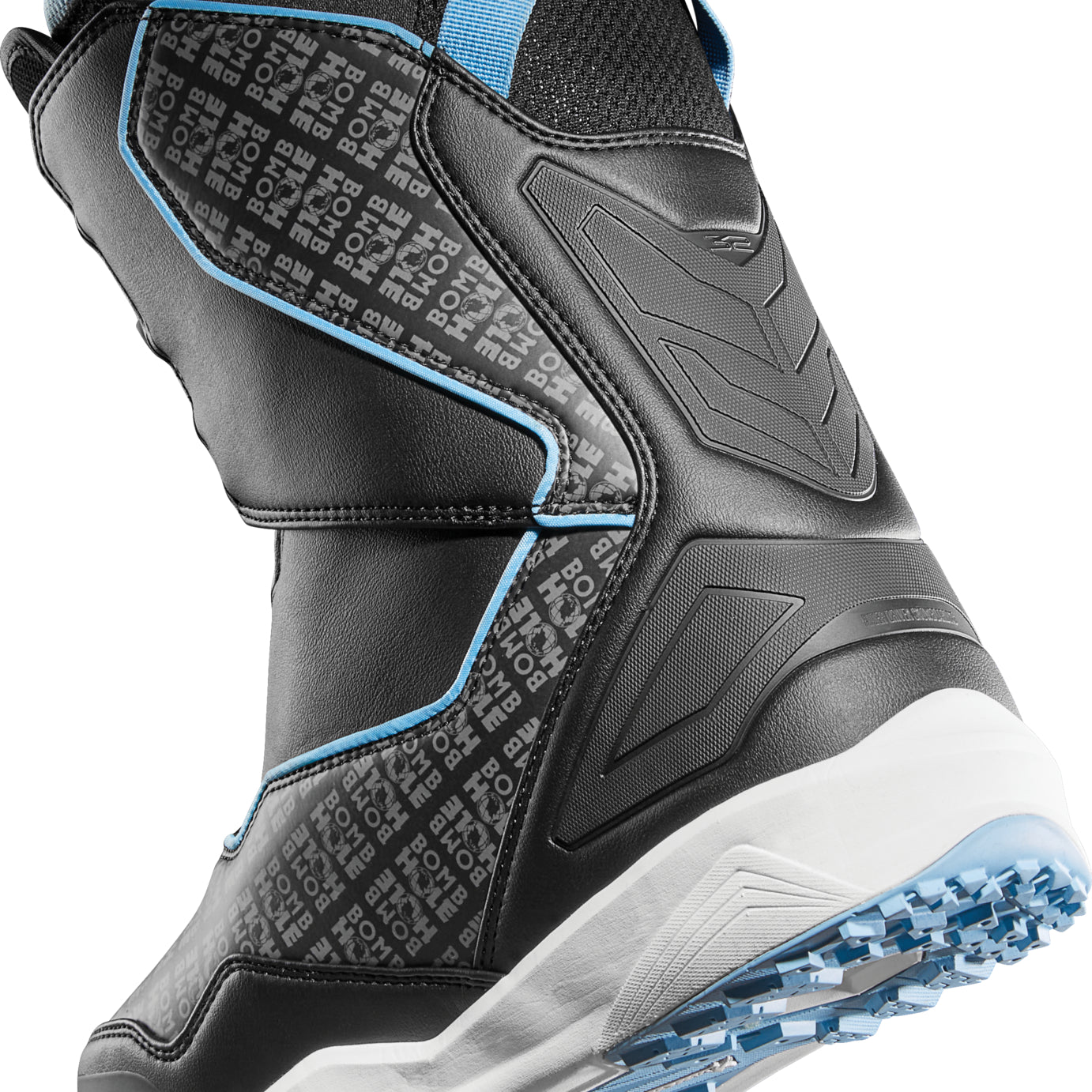 ThirtyTwo TM-2 Double BOA X Bomb Hole Snowboard Boot 2025 - Black snowboard boot with a textured pattern on the side and blue accents around the ankle strap.