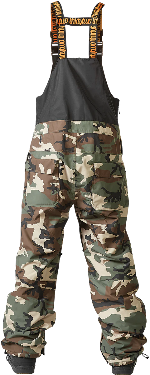 ThirtyTwo Basement Shell Bib Pant 2024 - Black bib shell pant with white and grey snow camo pattern on lower legs.