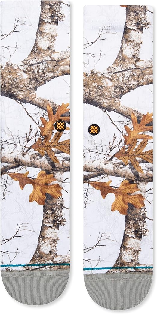 Stance X Realtree Edge Color Crew Sock 2023 - A pair of crew socks with a brown and tan camouflage pattern featuring tree branches and leaves.