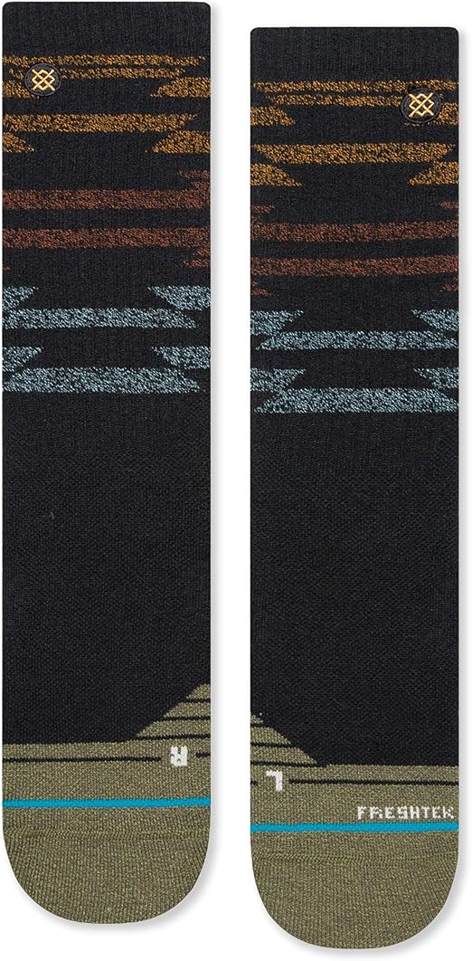 Stance Blanket Statement Socks 2023 - A pair of black socks with a repeating pattern of horizontal stripes in shades of brown and blue.