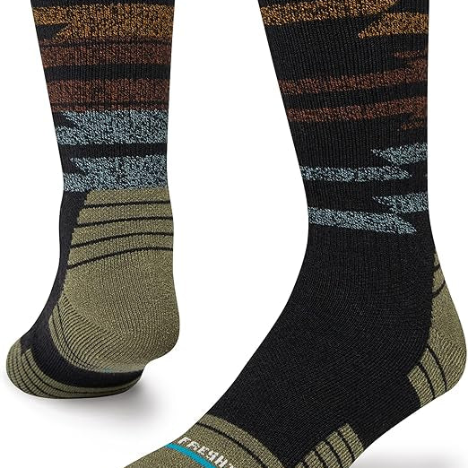 Stance Blanket Statement Socks 2023 - A pair of black socks with a brown and gray patterned design on top.