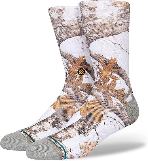 Stance X Realtree Edge Color Crew Sock 2023 - A pair of crew socks with a brown and tan camouflage pattern on a white background.