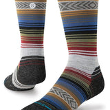 Stance Lightweight Wool Hiking Socks 2024 - A pair of hiking socks with a subtle pattern of thin stripes in various earthy tones, including brown and green.