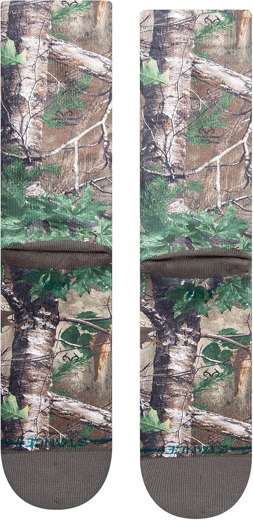 Stance x Realtree Kid's Xtra Crew Sock 2023 - Camo pattern with green leaves and brown branches on a light-brown background.