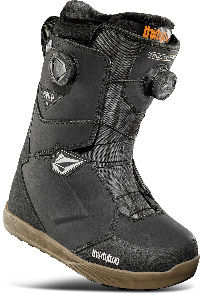 ThirtyTwo Women's Lashed Double BOA X Volcom Snowboard Boot 2025 - Black snowboard boot with a white logo on the side and a black strap with silver hardware.