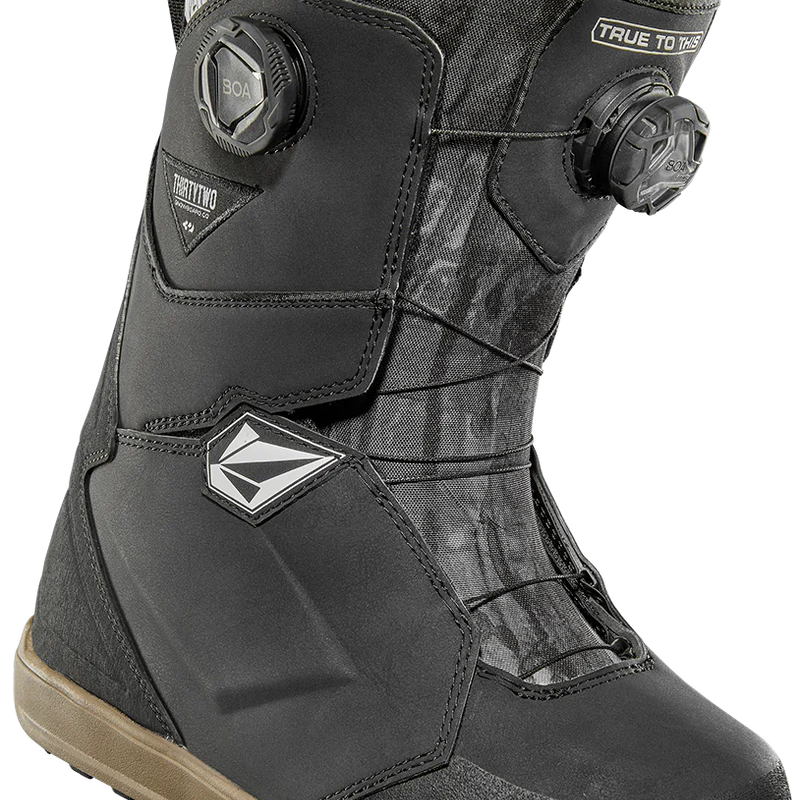 ThirtyTwo Women's Lashed Double BOA X Volcom Snowboard Boot 2025 - Black snowboard boot with a white logo on the side and a black strap with silver hardware.