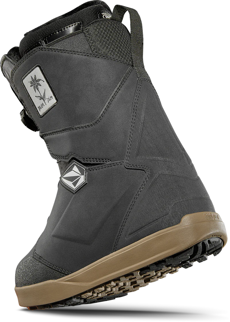 ThirtyTwo Women's Lashed Double BOA X Volcom Snowboard Boot 2025 - A black snowboard boot with a white logo patch on the side featuring a palm tree and the word "Volcom" in cursive.