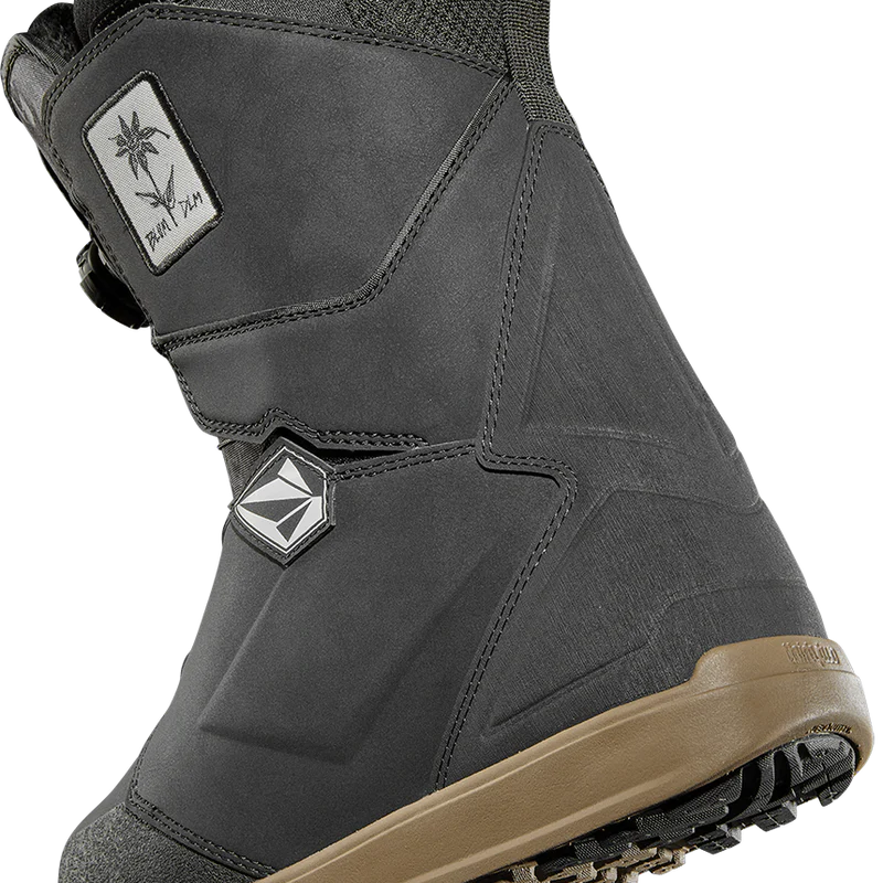 ThirtyTwo Women's Lashed Double BOA X Volcom Snowboard Boot 2025 - A black snowboard boot with a white logo patch on the side featuring a palm tree and the word "Volcom" in cursive.
