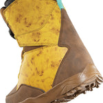 ThirtyTwo Junior's Lashed BOA X Fava Snowboard Boot 2025 - A brown snowboard boot with a black strap and white logo on top, featuring a marbled yellow pattern on the side.