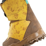 ThirtyTwo Junior's Lashed BOA X Fava Snowboard Boot 2025 - A brown snowboard boot with a black strap and white logo on top, featuring a marbled yellow pattern on the side.