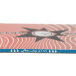 Nitro Alternator X Volcom Snowboard 2025 - A pink snowboard with a black starburst design on top of white wavy lines.