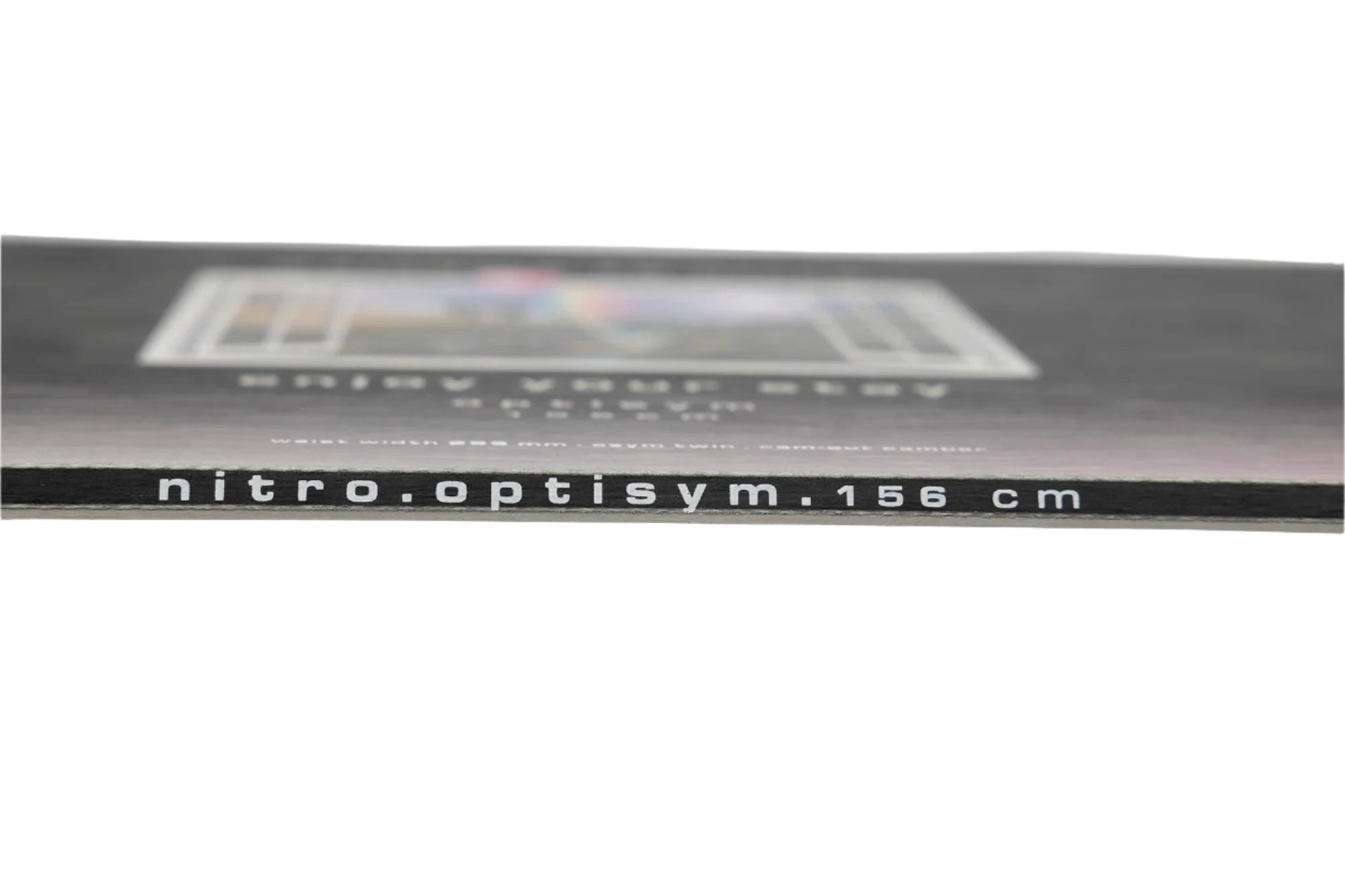 Nitro Optisym Snowboard 2025 - A black snowboard with a white logo on top and a blurry image of a colorful graphic in the background.