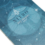 Nitro Women's Mystique Snowboard 2025 - A blue snowboard with a white and black graphic of a woman in a dress on it.