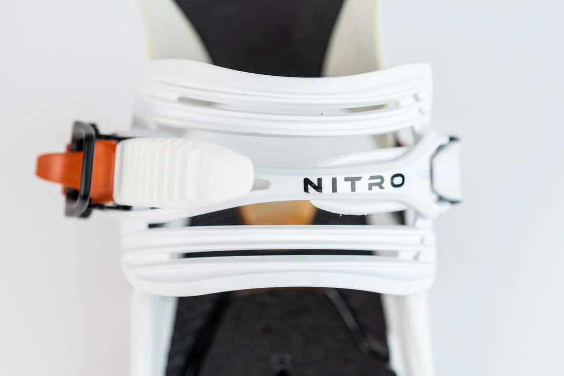 Nitro Phantom Snowboard Bindings 2025 - A pair of white snowboard bindings with a black strap and silver screws.