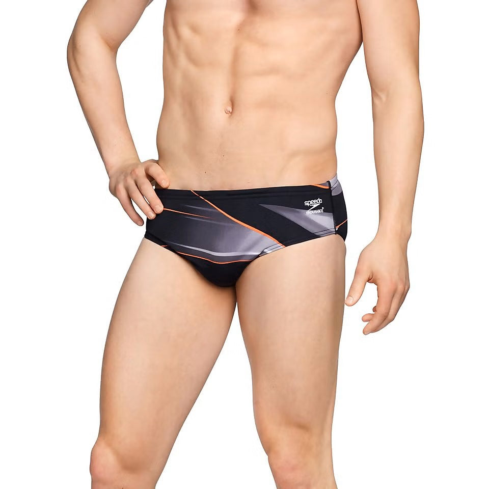 Speedo Infinite Pulse Brief Swimsuit - A black swimsuit with a geometric pattern of orange and gray lines.
