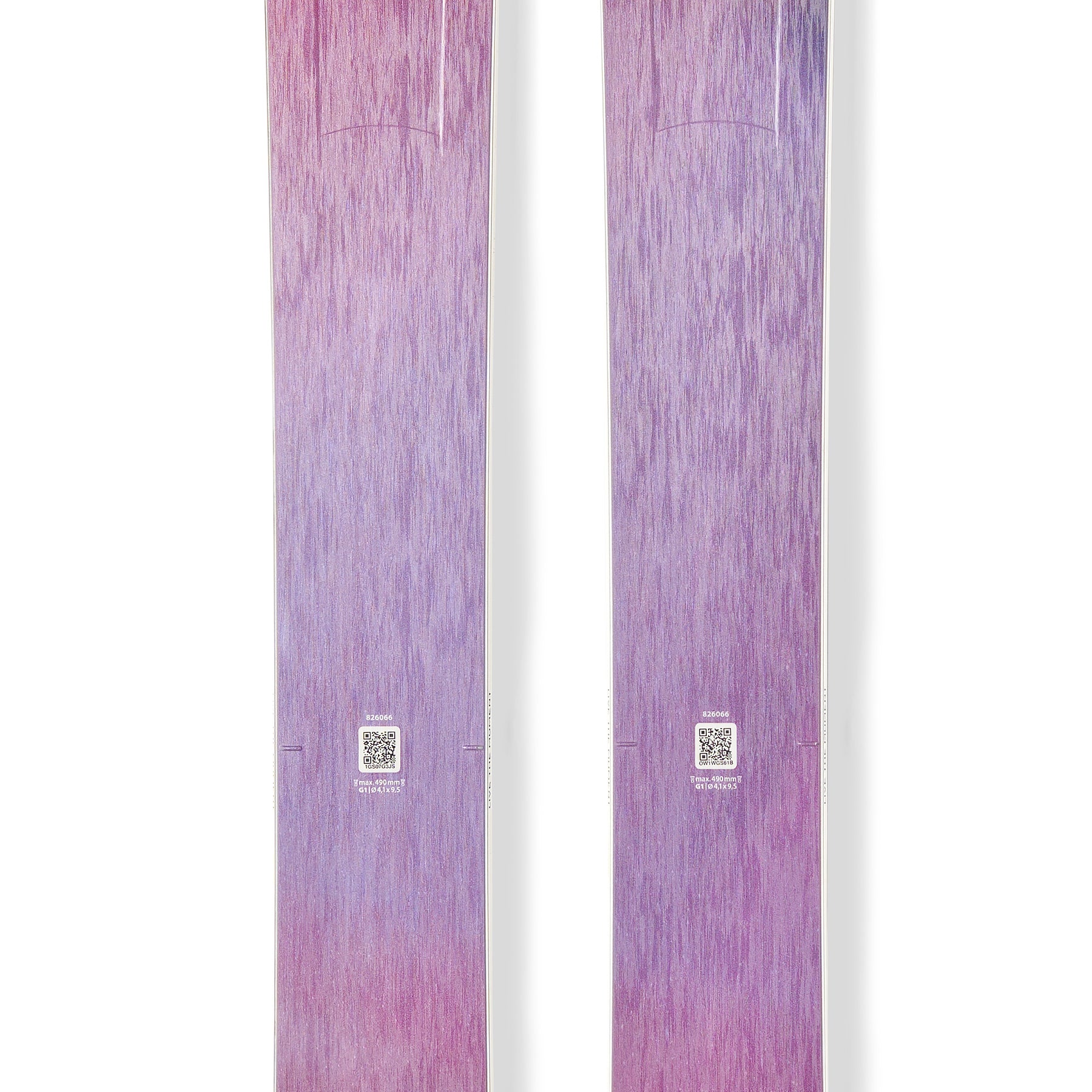 Purple and pink downhill skis with circular logo decals on the top surface.