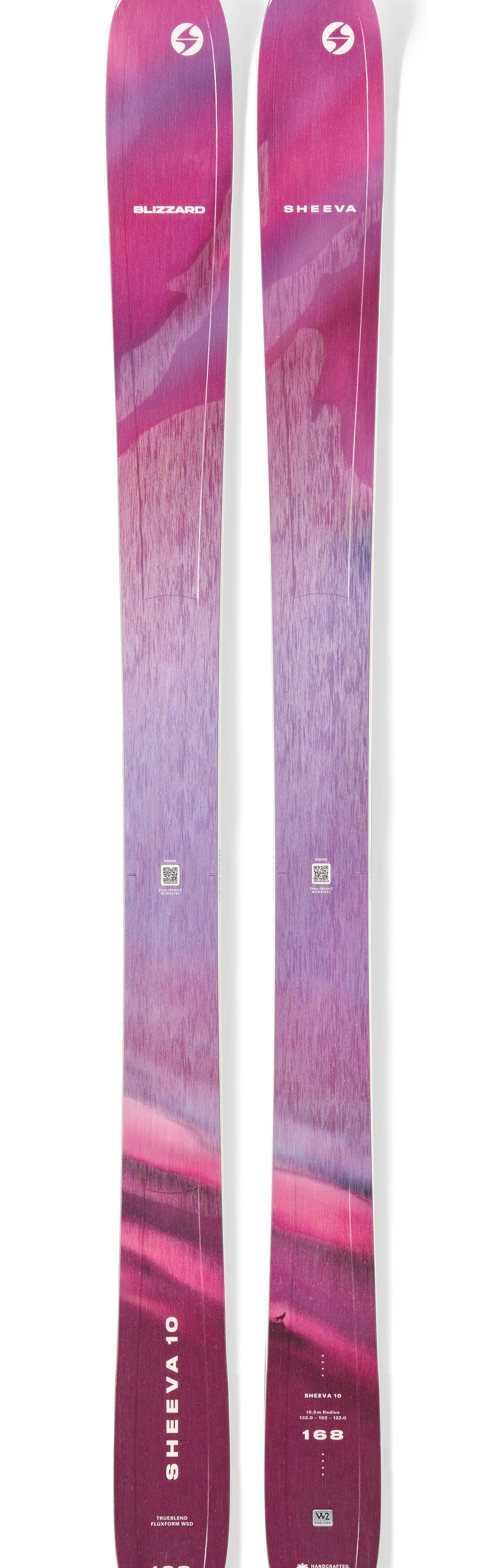Purple and pink downhill skis with circular logo decals on the top surface.