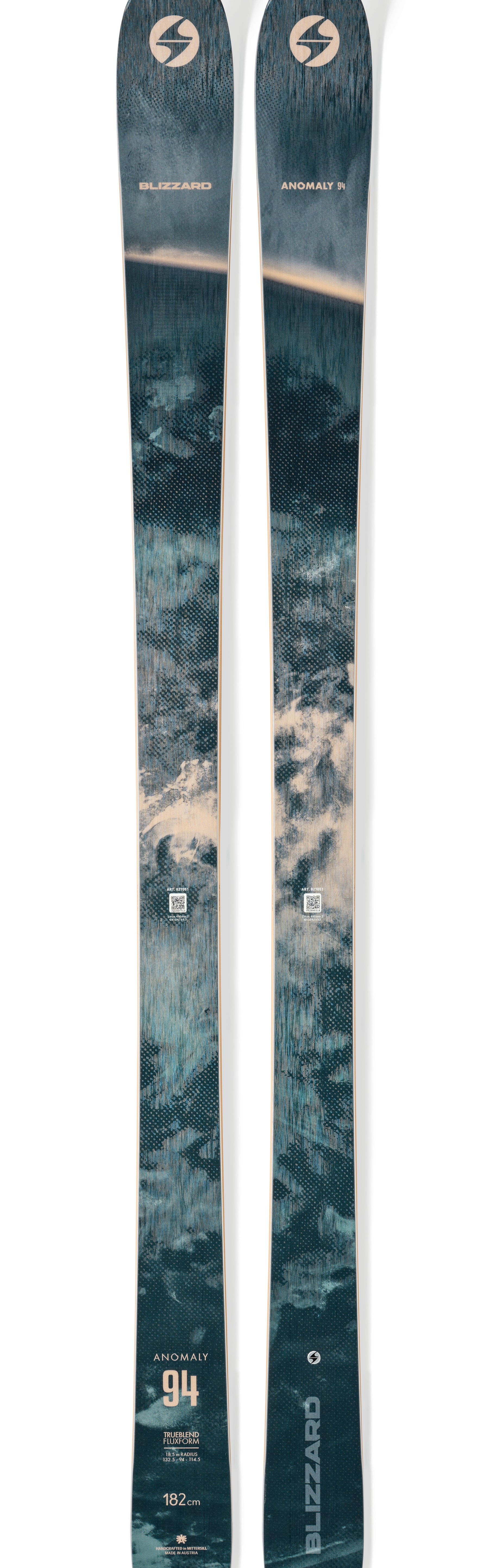 Teal skis with gold trim and circular brand logos, full-length pair.