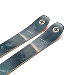 Teal ski top pair with circular logos and gold sidewalls, angled close-up.