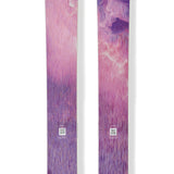 Purple and pink skis with Blizzard logo and circular emblem on top sheets.