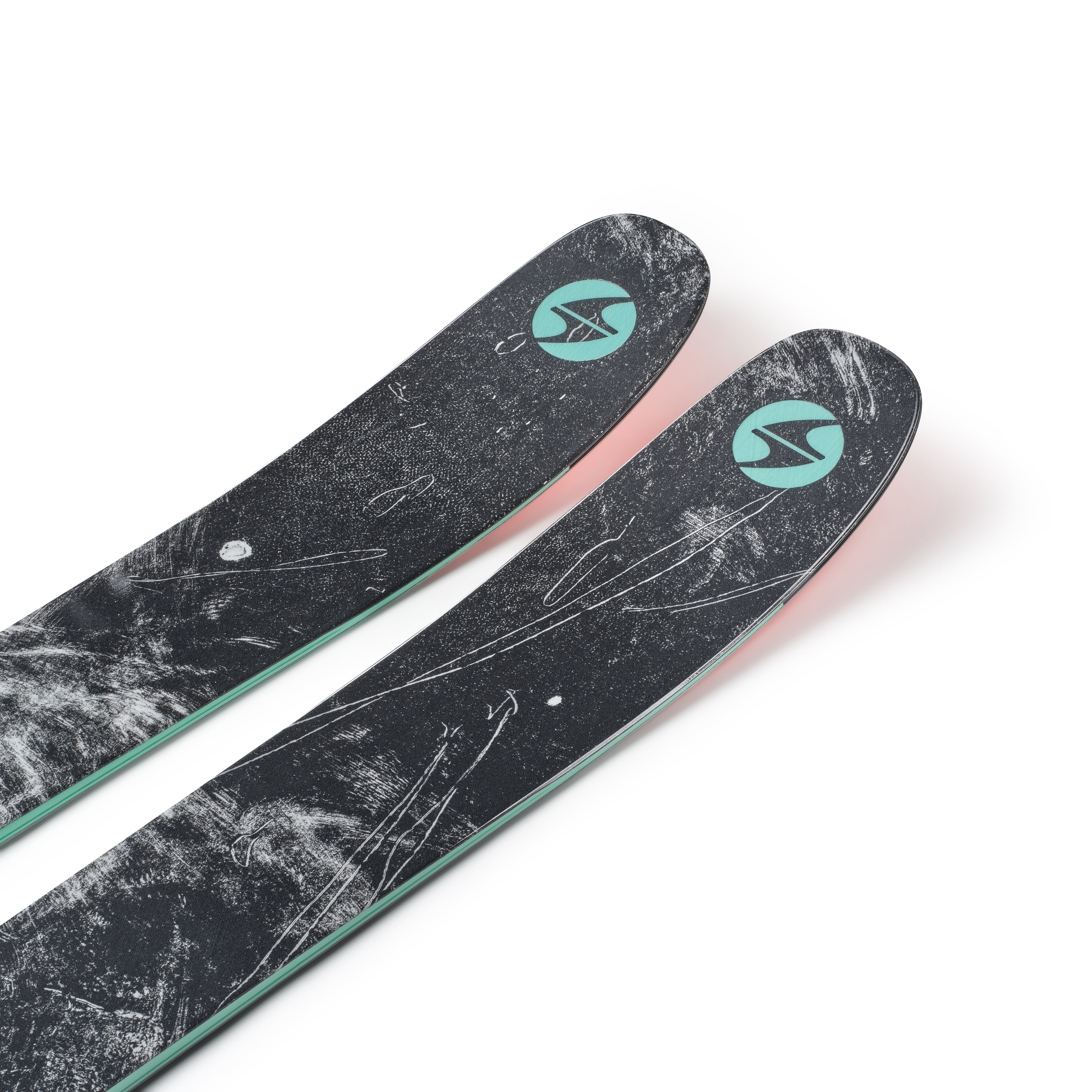 Pair of black skis with teal eye logos and mint-green base edge detail.