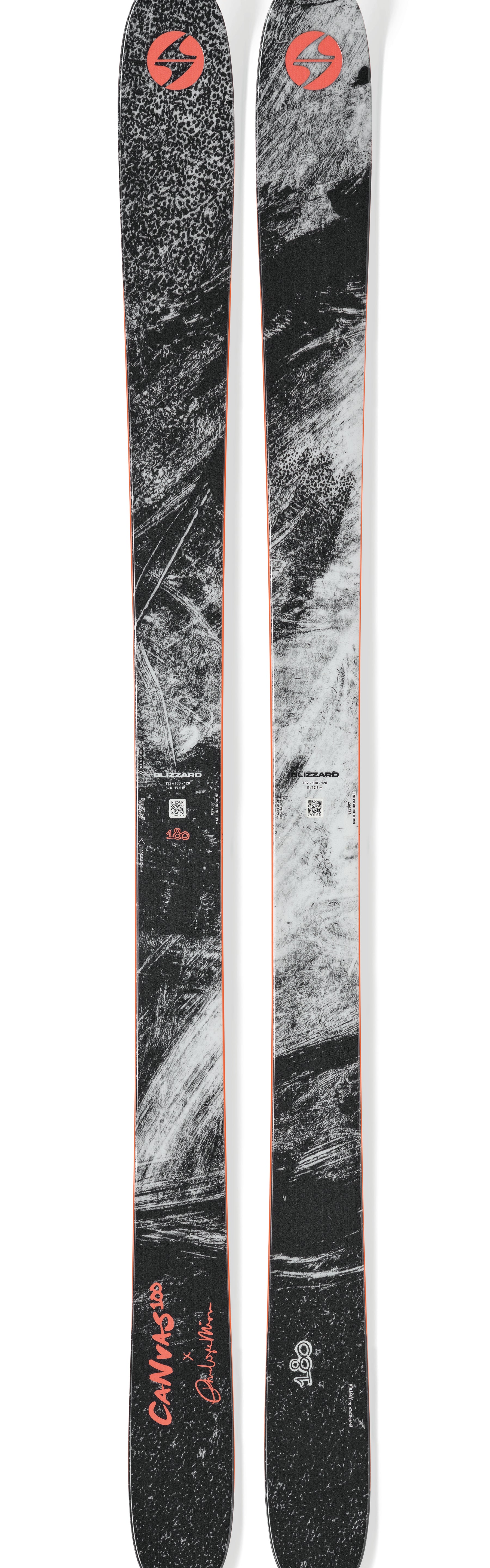 Pair of black, gray speckled skis with orange center stripe and Blizzard logo