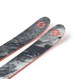 Two black skis with gray speckled tops and orange edges, angled view