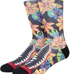 Stance Bomin Crew Sock 2024 - A pair of crew socks with a black background and colorful floral pattern featuring pink, yellow, blue, green, and purple flowers.