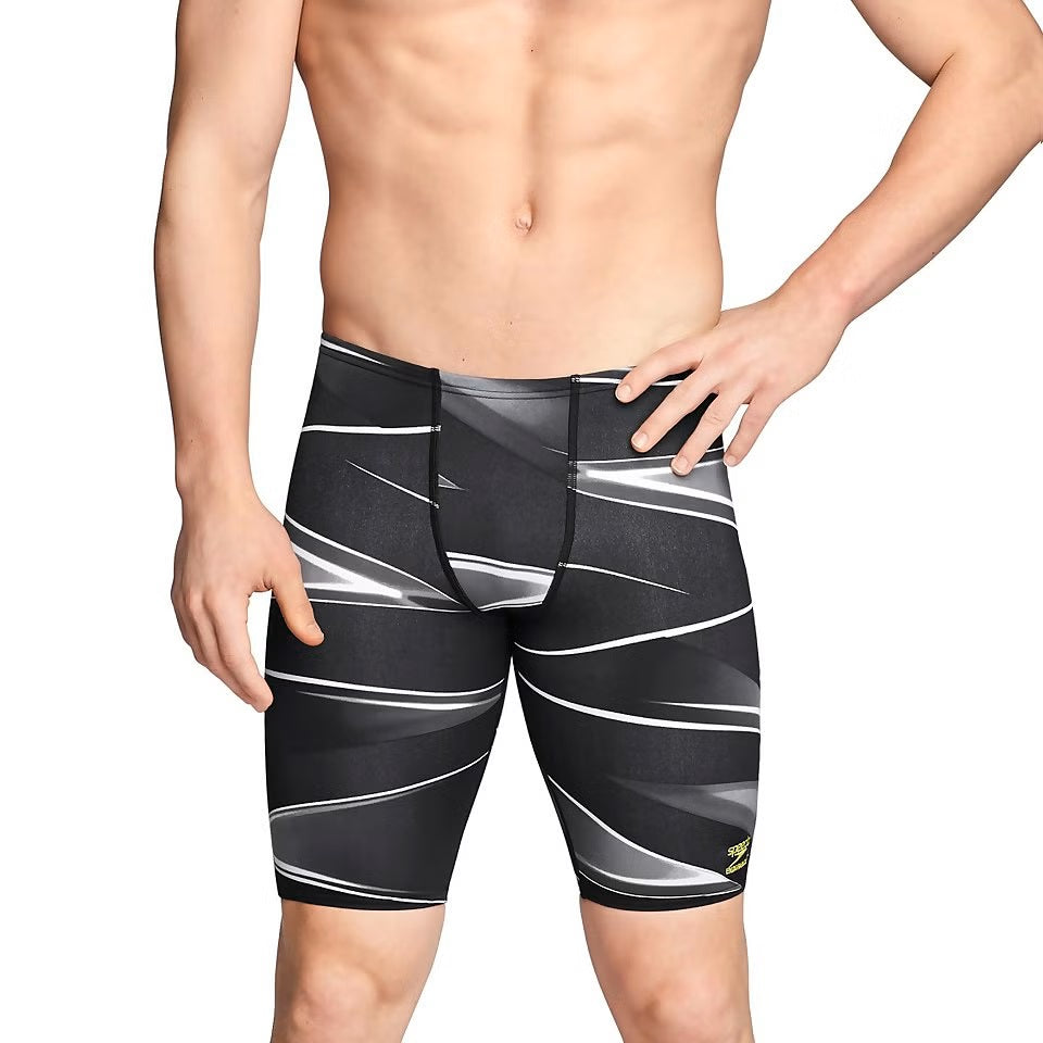 Speedo Infinite Pulse Jammer Swimsuit - A black swimsuit with a geometric pattern of white and gray lines, featuring a yellow logo on the left leg.