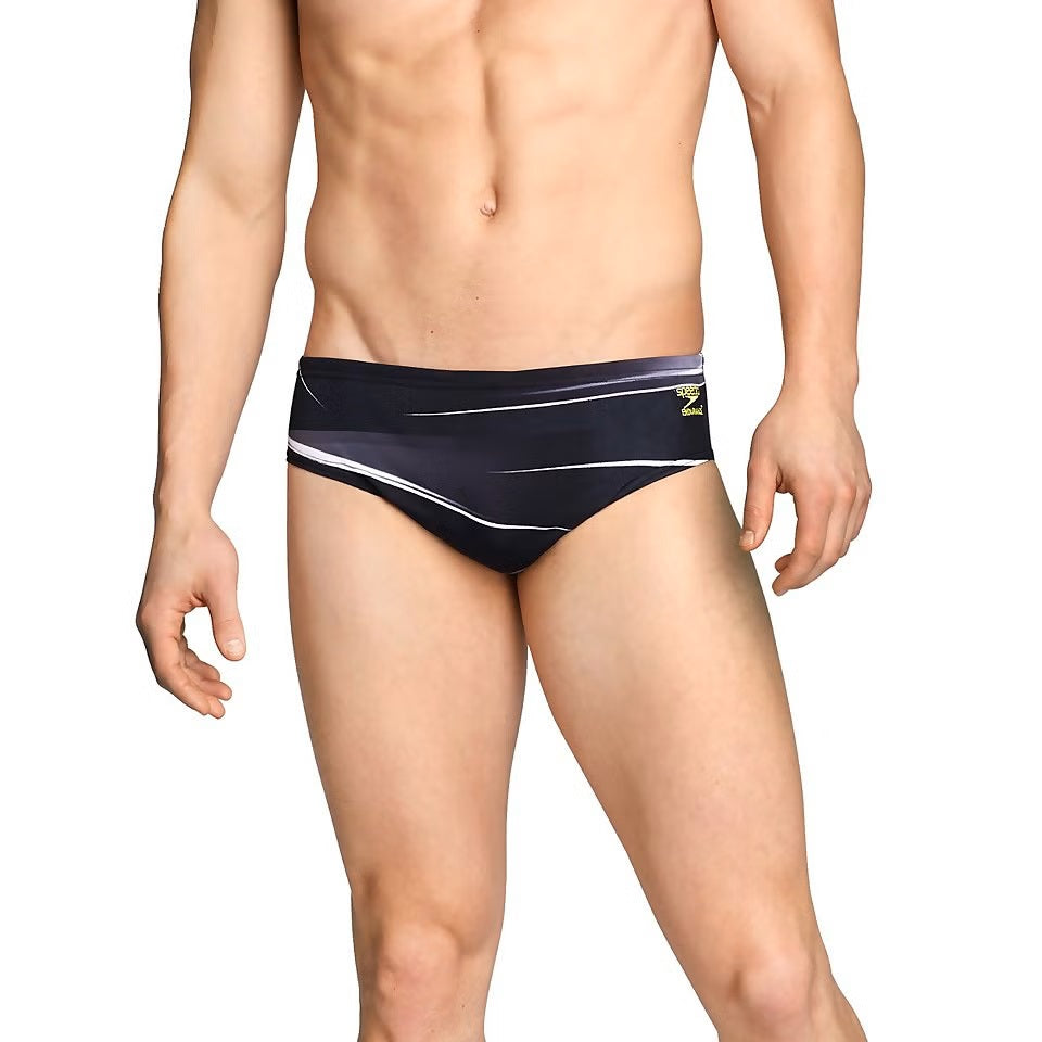 Speedo Infinite Pulse Brief Swimsuit - A black swimsuit with a white geometric pattern and a small yellow logo on the left hip.