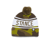 Stance OG Pom Beanie 2024 - A brown beanie with a pom-pom on top and an embroidered "STANCE" logo in white.