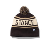 Stance OG Pom Beanie 2024 - A black beanie with a tan stripe and a brown pom-pom on top.