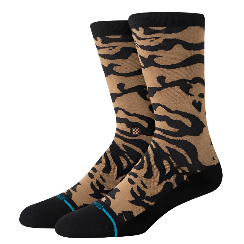 Stance Animalistic Crew Sock 2024 - A pair of tan crew socks with a black zebra-like pattern and blue accents on the toes.