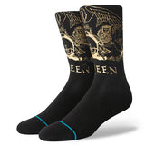 Stance X Queen Golden Crew Socks 2024 - A pair of black crew socks with a gold foil Queen logo on top and a repeating pattern of the same logo along the sides.