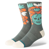 SKELLY NELLY CREW SOCK 2024 - A pair of gray crew socks with a large teal skull graphic on the top portion, surrounded by orange and white leaves.
