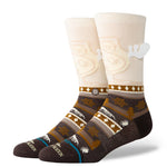 Stance Have Some Eggnog Crew Sock 2025 - A pair of crew socks with a festive eggnog design, featuring a light brown background and white snowflakes.