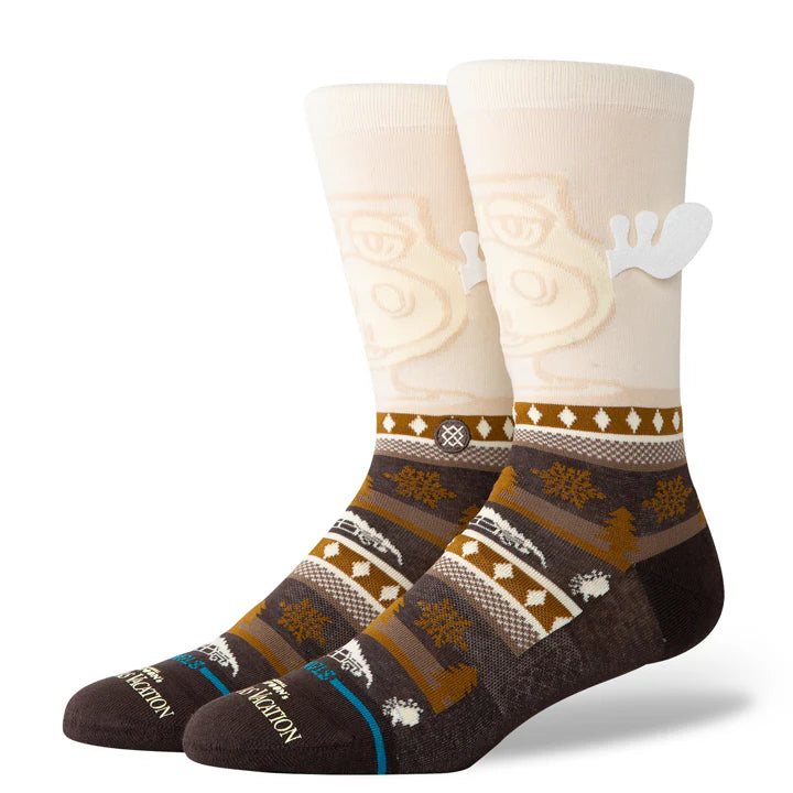 Stance Have Some Eggnog Crew Sock 2025 - A pair of crew socks with a festive eggnog design, featuring a light brown background and white snowflakes.