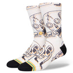 TALKIN HEADS CREW C SOCK 2023 - A pair of white crew socks with a repeating pattern of cartoon heads in various expressions, outlined in black and orange.
