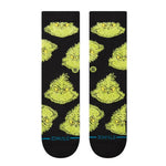 Stance Mean One Crew Sock 2025 - A pair of crew socks featuring a cartoonish illustration of the Grinch's face in green with yellow eyes and eyebrows, on a black background.