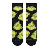 Stance Mean One Crew Sock 2025 - A pair of crew socks featuring a cartoonish illustration of the Grinch's face in green with yellow eyes and eyebrows, on a black background.