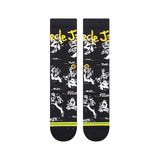 Stance Circle Jerks X Stance Crew Socks 2023 - Black crew socks with white and yellow graphics of a man playing guitar, featuring the words "Circle Jerks" in yellow at top.