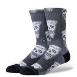 Stance Pizza Face Casual Crew Sock 2024 - A pair of crew socks with a repeating pattern of white pizza slices featuring black eyes and mouths, set against a dark gray background.
