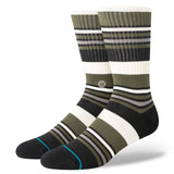 MOSSY CREW SOCK 2024 - Moss-colored crew socks with a repeating pattern of thin white stripes and a small logo on the ankle.