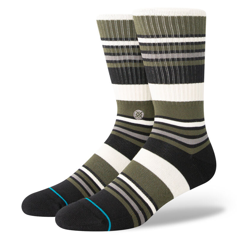 MOSSY CREW SOCK 2024 - Moss-colored crew socks with a repeating pattern of thin white stripes and a small logo on the ankle.